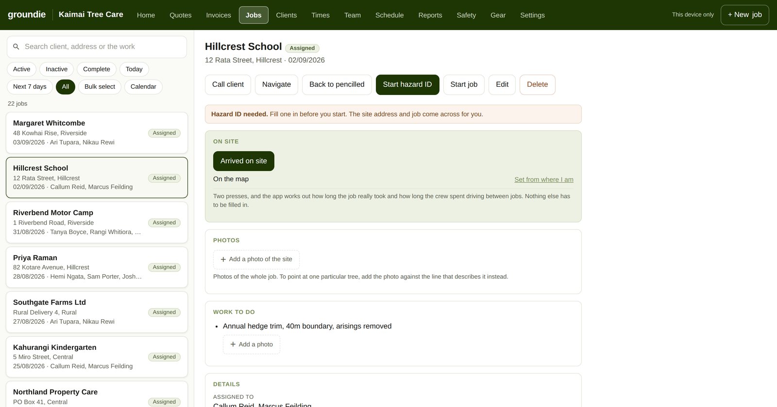 The same Hillcrest School work as a job sheet: site address, who is on it, a hazard ID warning, an arrived-on-site button and the work to do. No prices appear anywhere on the screen.